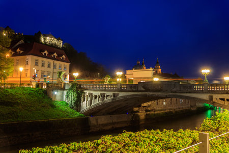 Night view of Dragon bridge over the Ljubljanica river in Ljubljana, Sloveniaの写真素材