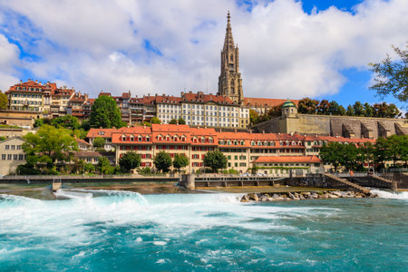 View of the old town of Bern with cathedral and dam on the Aare river, Switzerland