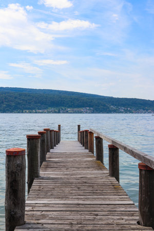 Wooden pier overlooking the Alps and Lake Constance in Switzerlandの写真素材