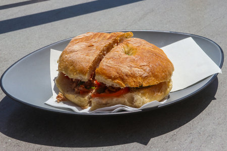 Typical Maltese bread ftira with tasty filling on a table