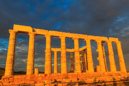 Greece Cape Sounio. Ruins of an ancient temple of Poseidon, Greek god of the sea, on sunset. Tourist landmark of Attica, Sounion, Greeceの写真素材