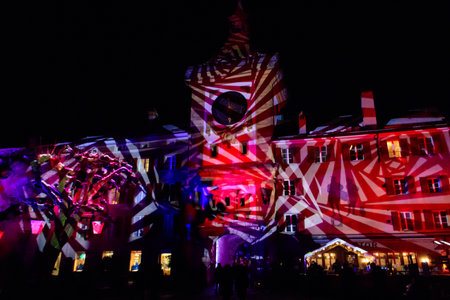 Murten, Switzerland - January 18, 2023: Brentor or Bern Gate with clock illuminated on the light festival in Murten, Switzerlandのeditorial素材