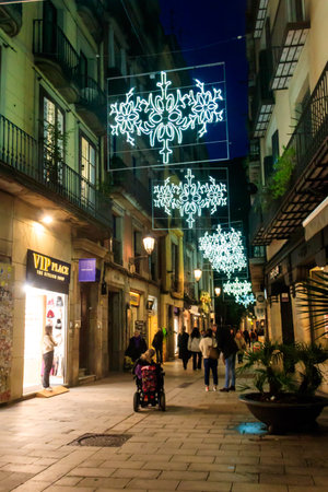 Barcelona, Spain - December 14, 2022: Night city street decorated by illumination for Christmas and New Year holidays in Barcelona, Spainのeditorial素材