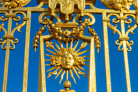 Close-up of Symbol of Louis XIV the Sun King (Roi du Soleil) on the golden gate of Royal Palace of Versailles, Franceの写真素材