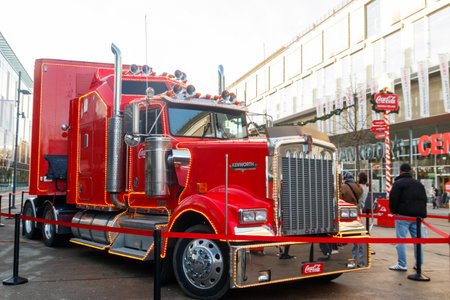 Bern, Switzerland - November 27, 2025: The red Coca Cola Christmas truck illuminated with bright holiday lights in Bern, Switzerlandのeditorial素材