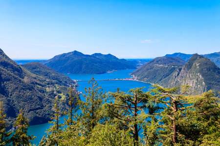 Scenic view of lake Lugano from Monte Bre mountain in Ticino canton, Switzerlandの写真素材