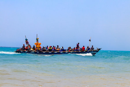 Stone Town, Zanzibar, Tanzania - September 20, 2021: Many african people in boat sailing along the...