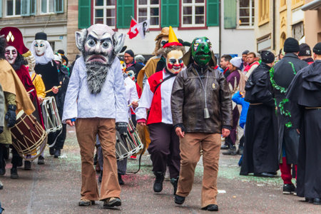 Basel, Switzerland - February 28, 2023: Carnival participants in costumes during the annual...