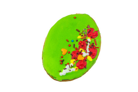 Green coloured egg shaped easter biscuit isolated on white background