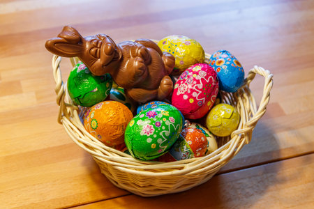 Basket with Easter eggs and Easter bunny on wooden table