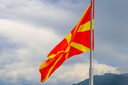 Flag of North Macedonia against blue skyの写真素材