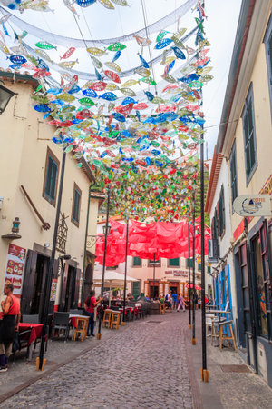 Camara de Lobos, Madeira, Portugal - June 17, 2024: Narrow street in the famous fishing village of Camara de Lobos in Madeira island, Portugalのeditorial素材