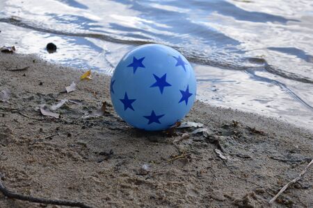 resting ball on the beachの写真素材
