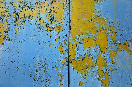 Old grunge colorful shabby metallic wall texture divided by line into two partsの写真素材