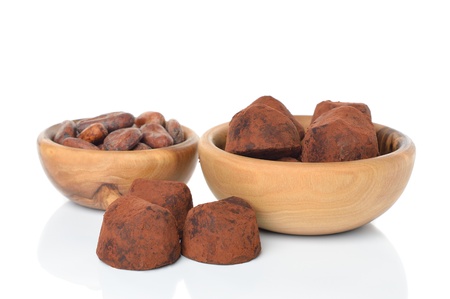 Chocolate truffles and cocoa beans on white background の写真素材