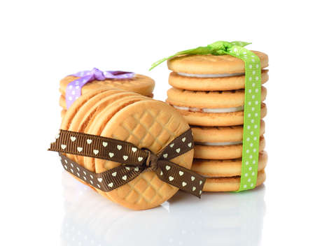 Cookies decorated with ribbons on white background