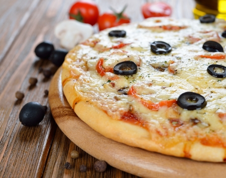 Fresh pizza on a brown tableの写真素材