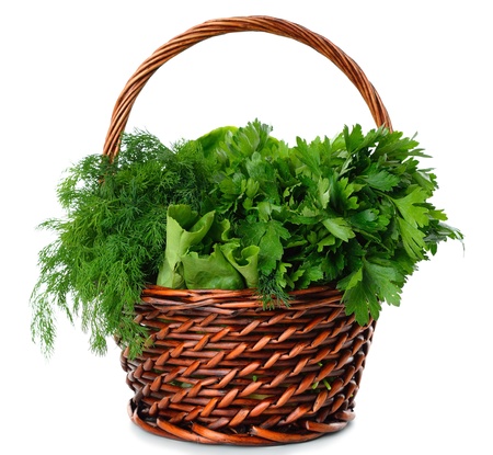 Parsley and dill in a brown basket isolated on white backgroundの写真素材