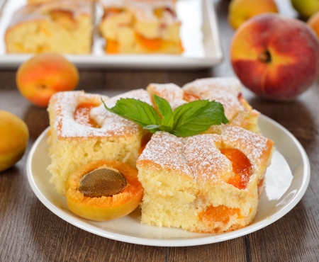 Cake with apricots on a brown tableの写真素材