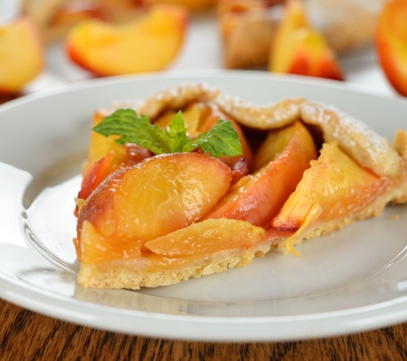 Tart with nectarines on a brown table close-upの写真素材