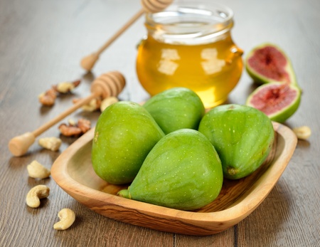 Figs with honey and nuts on a brown backgroundの写真素材