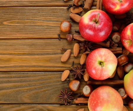 Apples, nuts and spices on a brown backgroundの写真素材