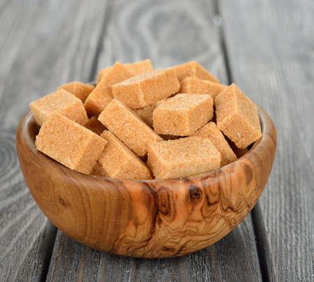 Brown sugar in a bowl on a gray backgroundの写真素材