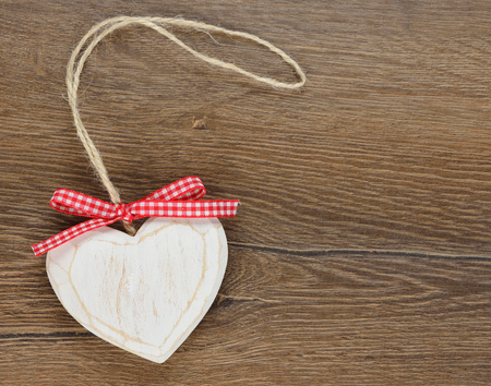 wooden heart on a brown backgroundの写真素材
