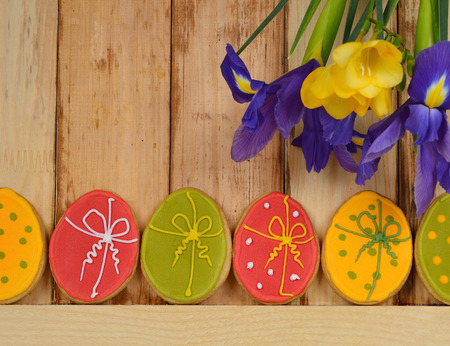 Easter cookies decorated with icing on a wooden background