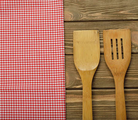 Wooden spoon and napkin on a brown backgroundの写真素材