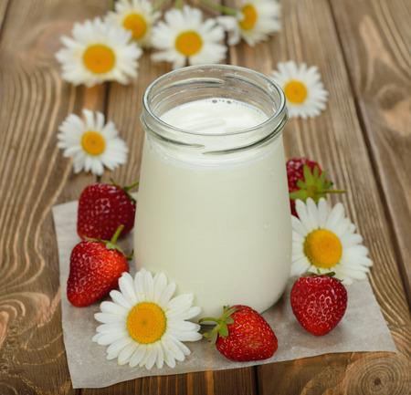 natural yoghurt in a jar on a brown backgroundの写真素材
