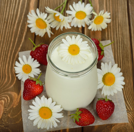 natural yoghurt in a jar on a brown backgroundの写真素材
