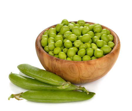 green peas in a wooden bowl on a white backgroundの写真素材