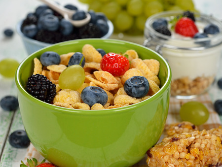 Corn flakes with berries on a white background