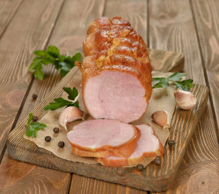 Smoked meat and spices on a brown background