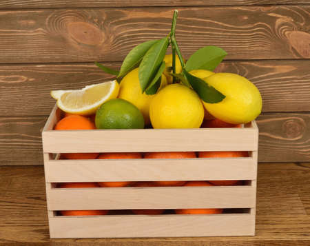 Fresh citrus fruit in a wooden boxの写真素材