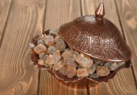 Caramelized sugar in a bowl on a brown backgroundの写真素材