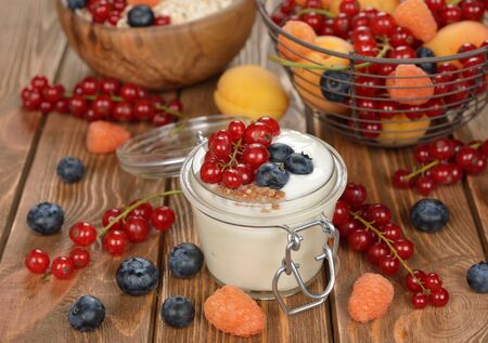 Natural yogurt with berries in a glass jarの写真素材