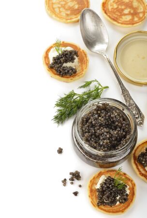 Natural black caviar in a glass jar on a white backgroundの写真素材