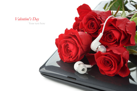 Computer and roses on a white background, Valentine's Day conceptの写真素材