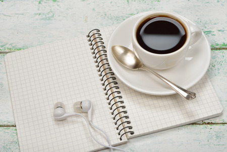 Notebook, headphones and coffee on a white backgroundの写真素材