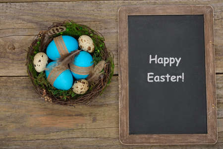 Eggs in a nest on a wooden background, Easter conceptの写真素材