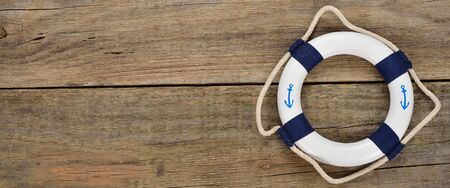 White lifebuoy on a wooden backgroundの写真素材