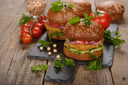 Vegetarian burger on a wooden backgroundの写真素材