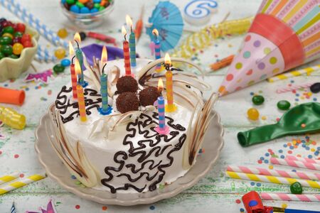 Birthday cake and various accessories for the holiday on a white background