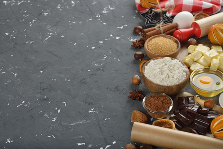 Raw ingredients for baking holiday cookies on a gray background