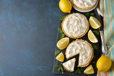 Lemon pie with meringue on a blue backgroundの写真素材