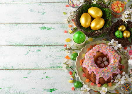 Easter cake, flowers and eggs on a white background