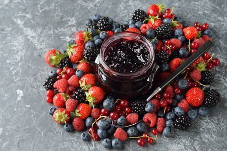 Jam from fresh forest berries on a gray backgroundの写真素材
