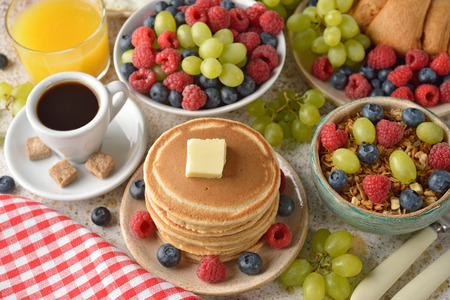 Pancakes with berries on a brown backgroundの写真素材